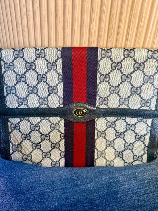 Gucci Handbags - Gucci Black Leather Accessory with Gold Logo Stamp
